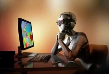 Un robot humanoïde assis devant un ordinateur coloré, symbolisant la dépendance à Internet