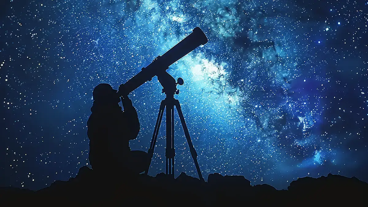 Silhouette d’un astronome observant un ciel étoilé à l’aide d’un télescope sous la Voie lactée