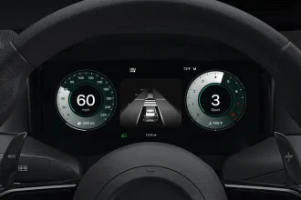 Apple CarPlay Ultra dashboard display with speedometer, ADAS lane view and tachometer inside steering wheel