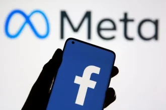 Logo de Facebook affiché sur un smartphone devant le logo de Meta, illustrant les risques numériques