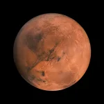 Vue détaillée de la planète Mars montrant sa surface rouge caractéristique, soulignée par des formations volcaniques et des vallées profondes.