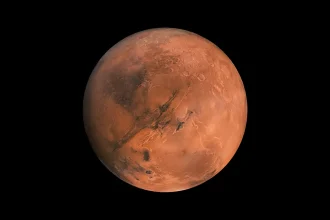 Vue détaillée de la planète Mars montrant sa surface rouge caractéristique, soulignée par des formations volcaniques et des vallées profondes.