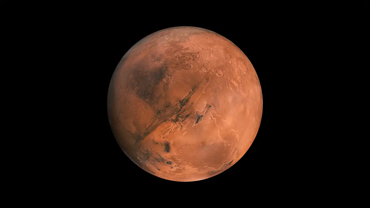 Vue détaillée de la planète Mars montrant sa surface rouge caractéristique, soulignée par des formations volcaniques et des vallées profondes.