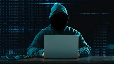 Faux antivirus Android, silhouette encapuchonnée devant un portable sur fond de code, illustration d’une menace d’app espion.