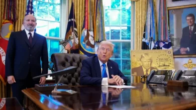 Le président signe une proclamation H-1B dans le Bureau ovale aux côtés d’un conseiller.